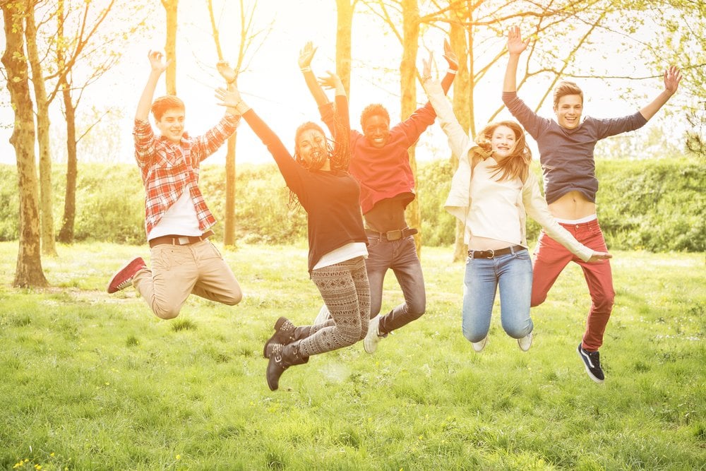 Teenagers Jumping Together