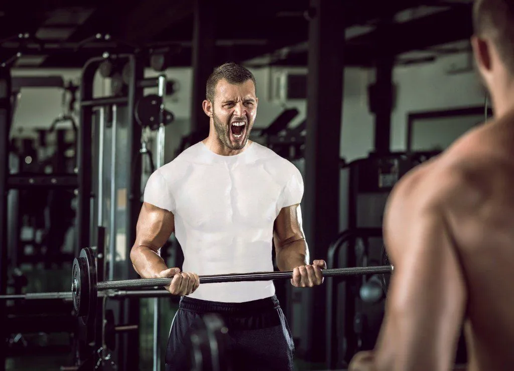 Man grunting in gym 