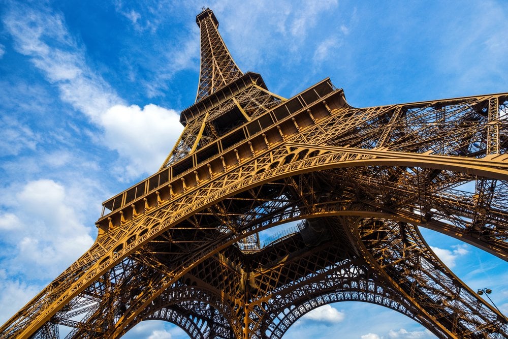 Gorgeous wide shot of Eiffel Tower with dramatic sky at late evening, Paris, France