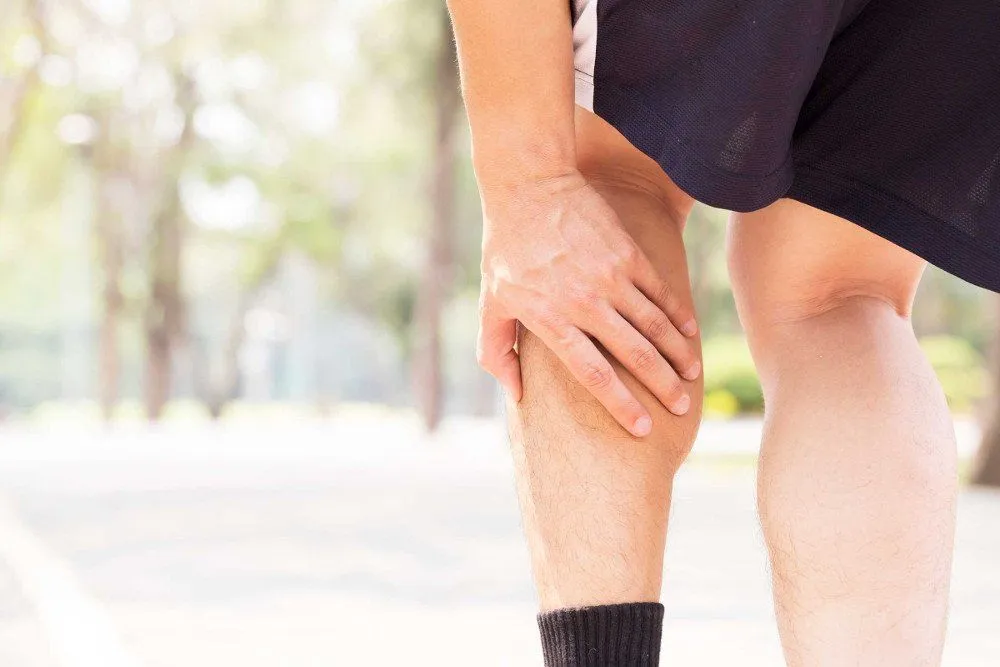 Cramp in leg while exercising. Sports injury concept