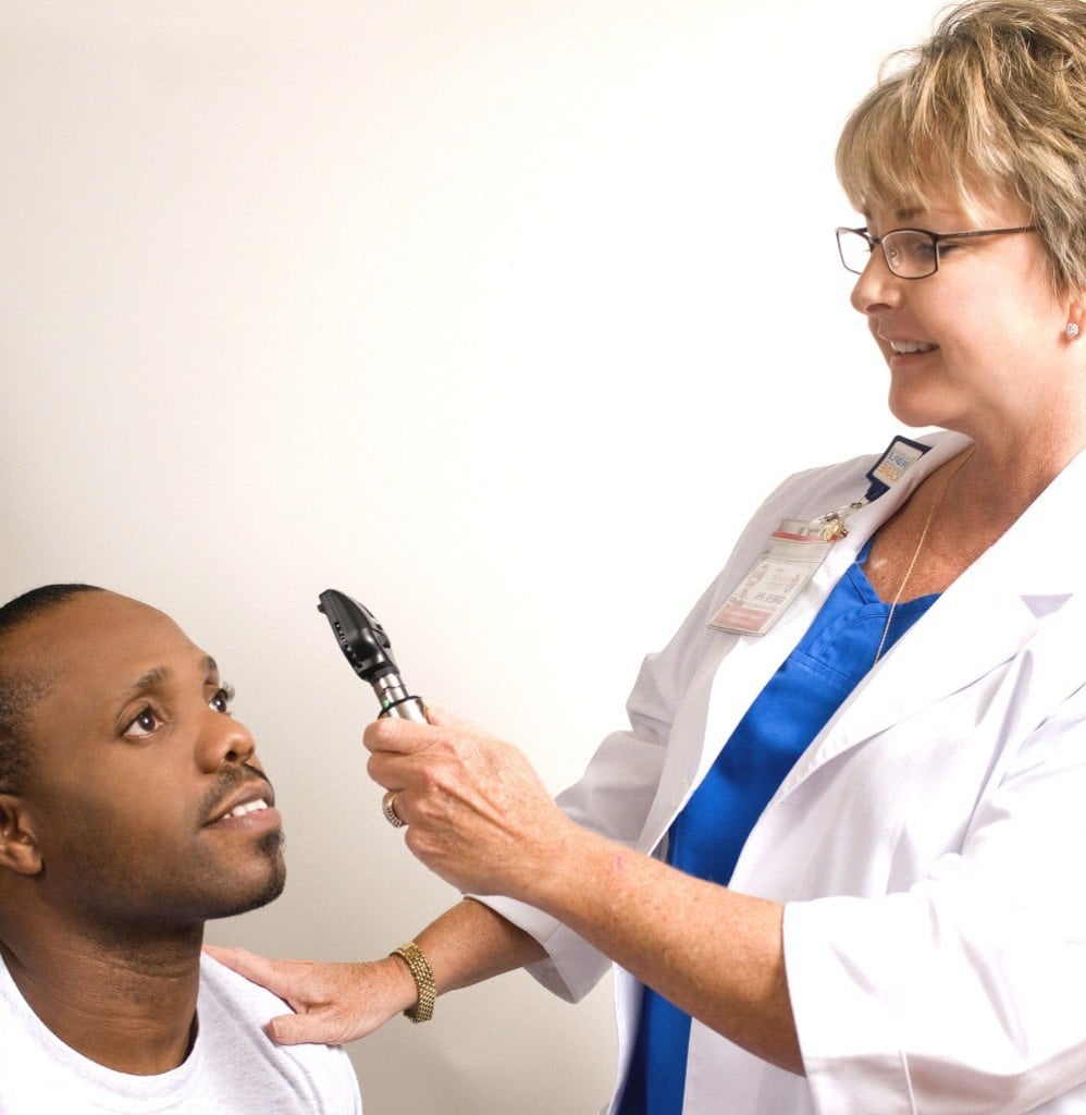 Doctor checking eye with torch