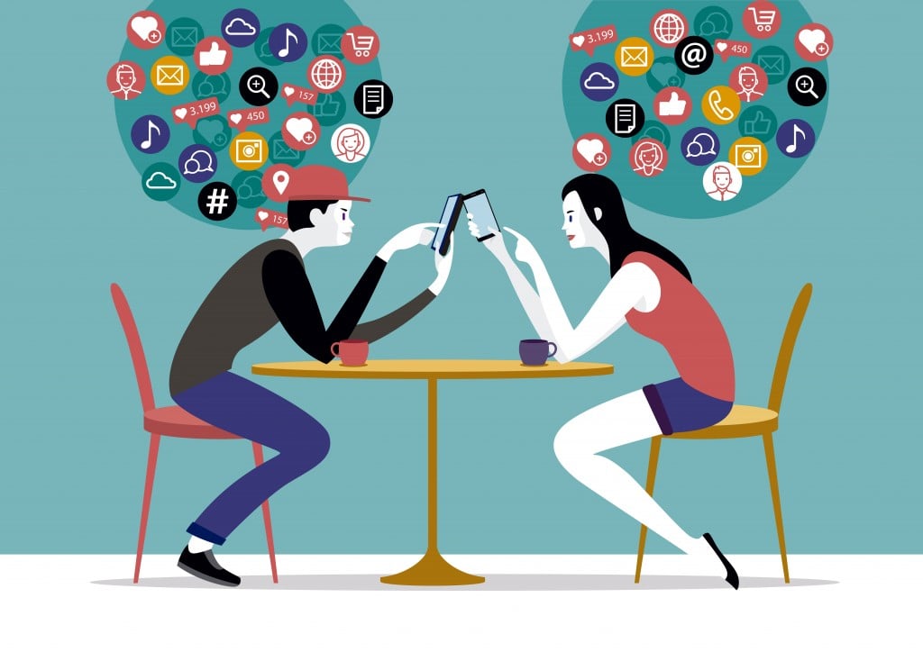 Millennial Couple sitting on a coffee using their smart phones( Jesus Sanz)s