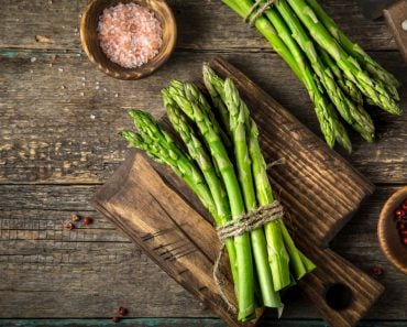 banches of fresh green asparagus on wooden background( Anna Shepulova)S
