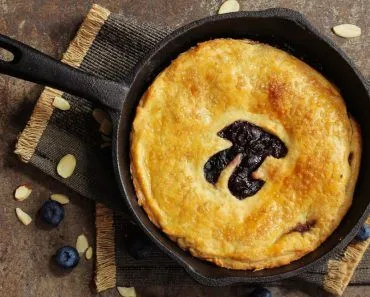 Pi Day special homemade blueberry pie baked in a skillet overhead view(vm2002)s