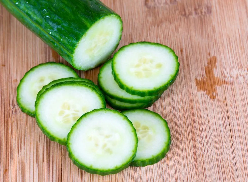 Sliced seedless cucumber over a wooden cutting board(BobNoah)S