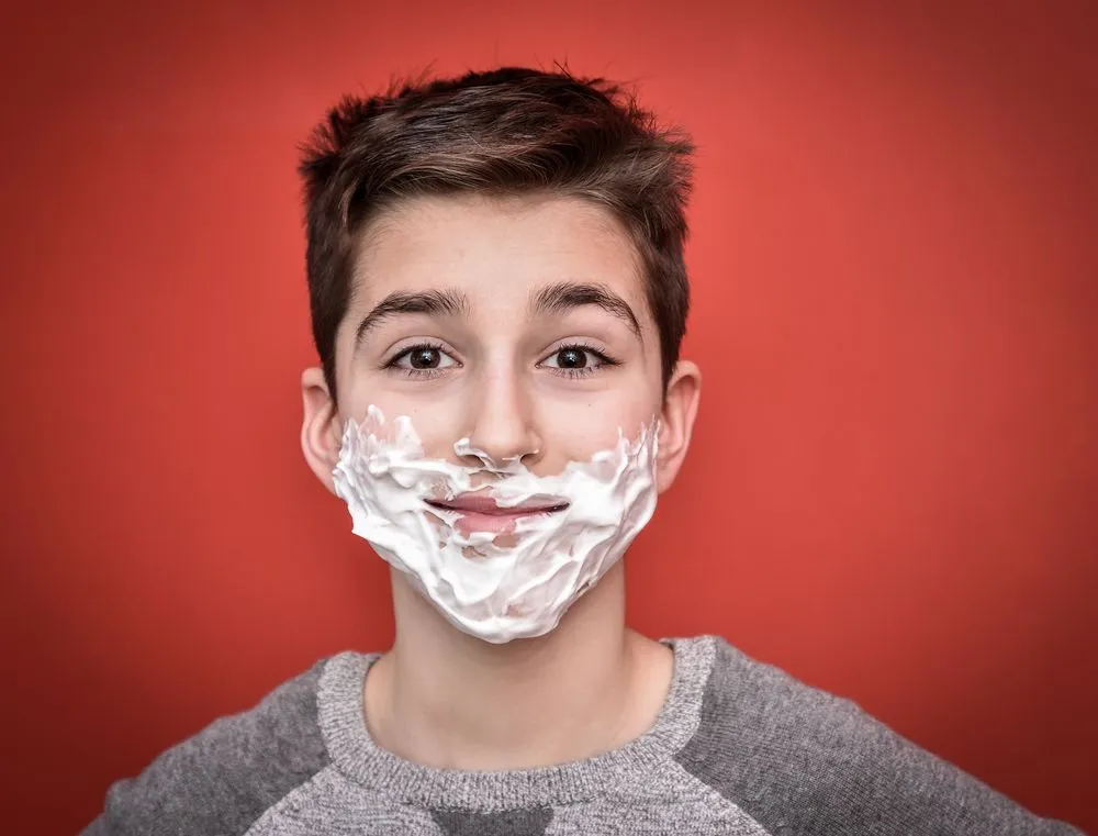 Smiling young boy with shaving foam on his face(Zdravinjo)s