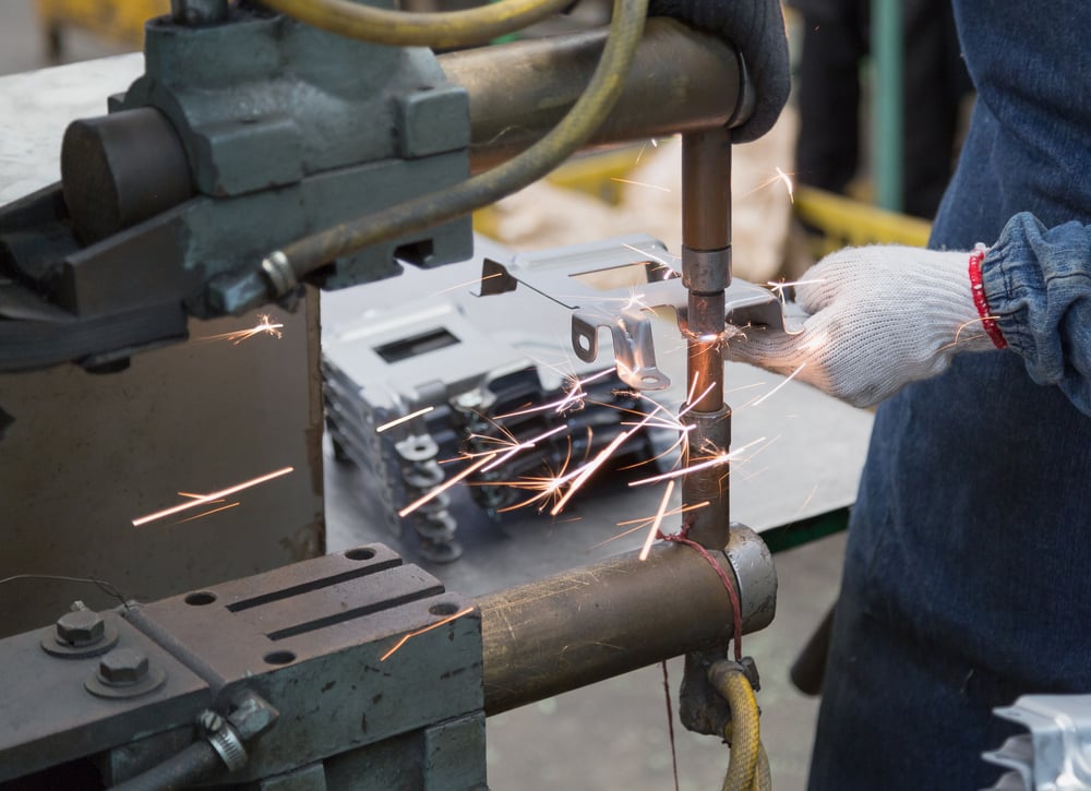 Operator is working with spot welding process for automotive part(sondoggie)s