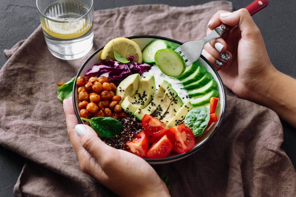 Woman is eating healthy lunch on dark background(Anna Kucher)s