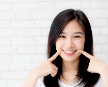 Portrait,Of,Beautiful,Young,Asian,Woman,Happiness,Standing,Finger,Touch