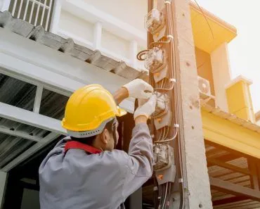 electricians-wear-safety-helmets-jackets-and-protective-gloves-using-a-screwdriver-install-a-meter-to_t20_QzOV1k