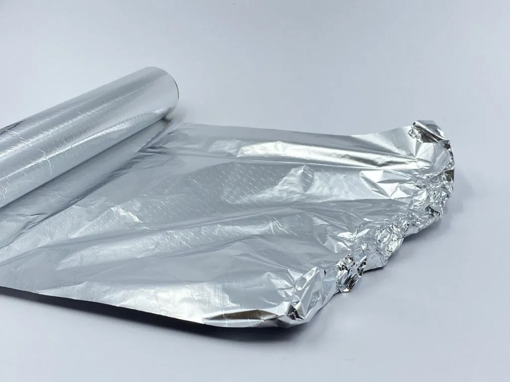 roll-of-aluminum-foil-with-sheet-pulled-out-and-crumpled-edges-on-light-background-with-space-for_t20_VJKanG