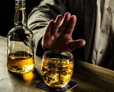 Man saying no more to alcohol with his body language