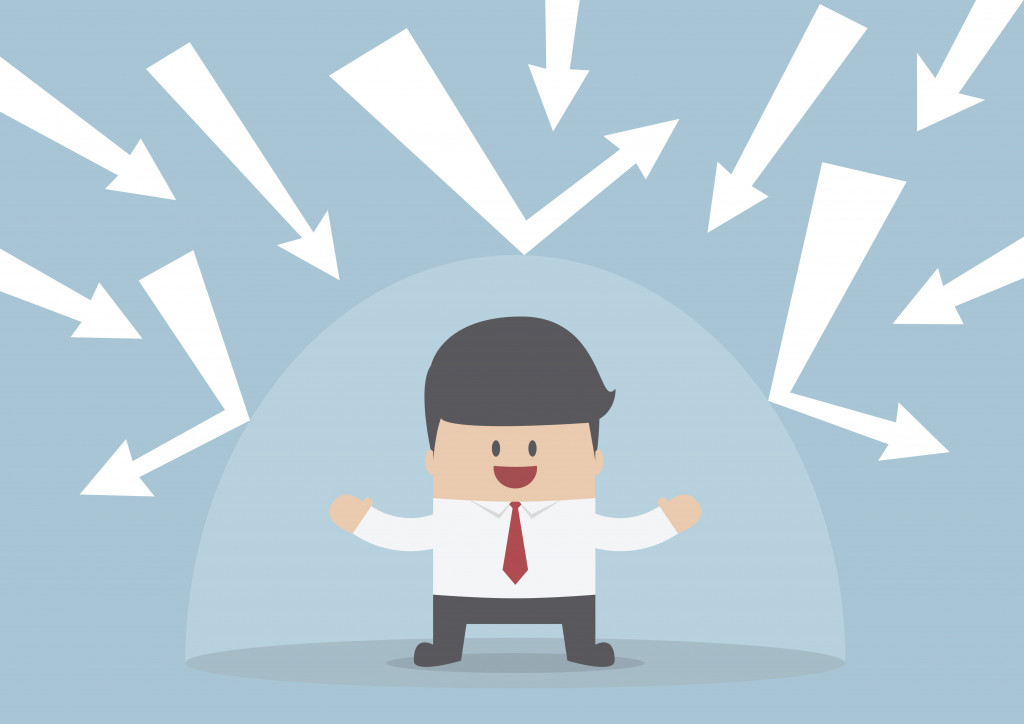 Businessman protected from the bad thing by the invisible shield