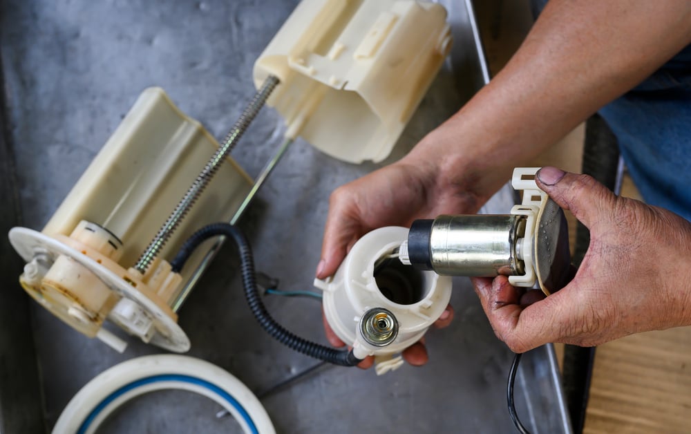 Car,Mechanic,Hands,Installing,An,Electric,Fuel,Pump,In,Car