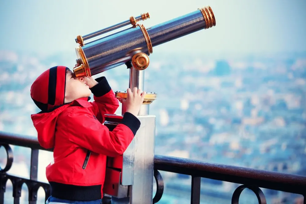 Child,Looking,Through,Coin,Operated,High,Powered,Binoculars,On,A