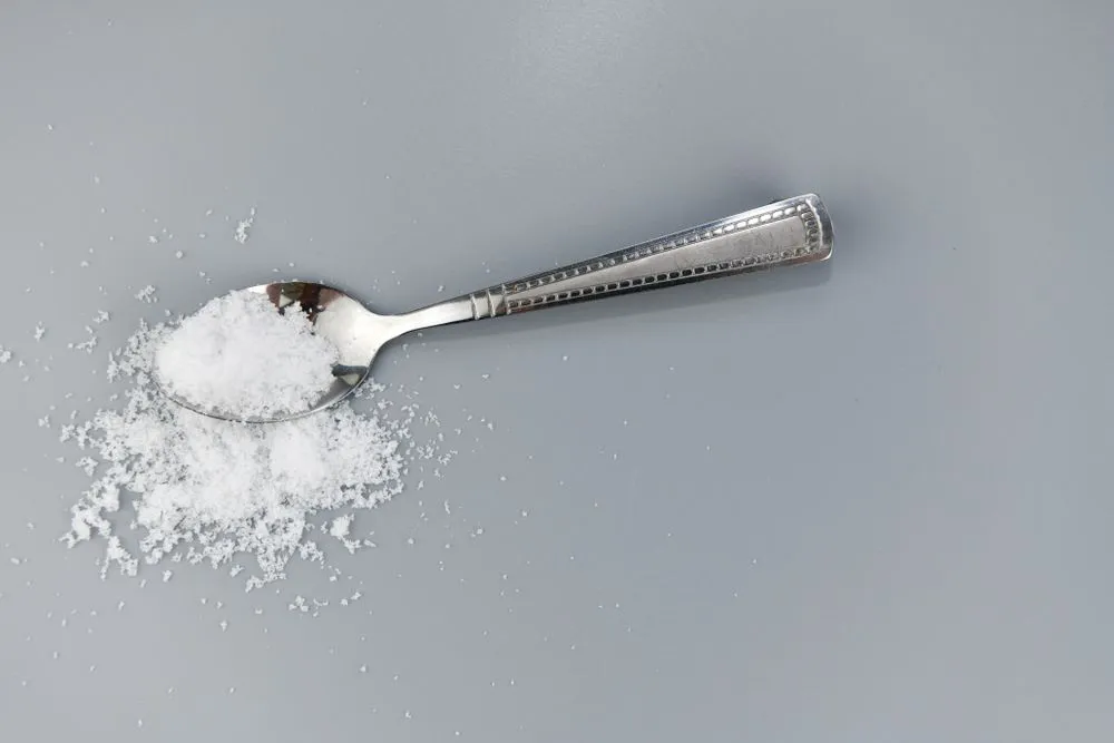 Silver,Spoon,With,Salt,On,Gray,Background.