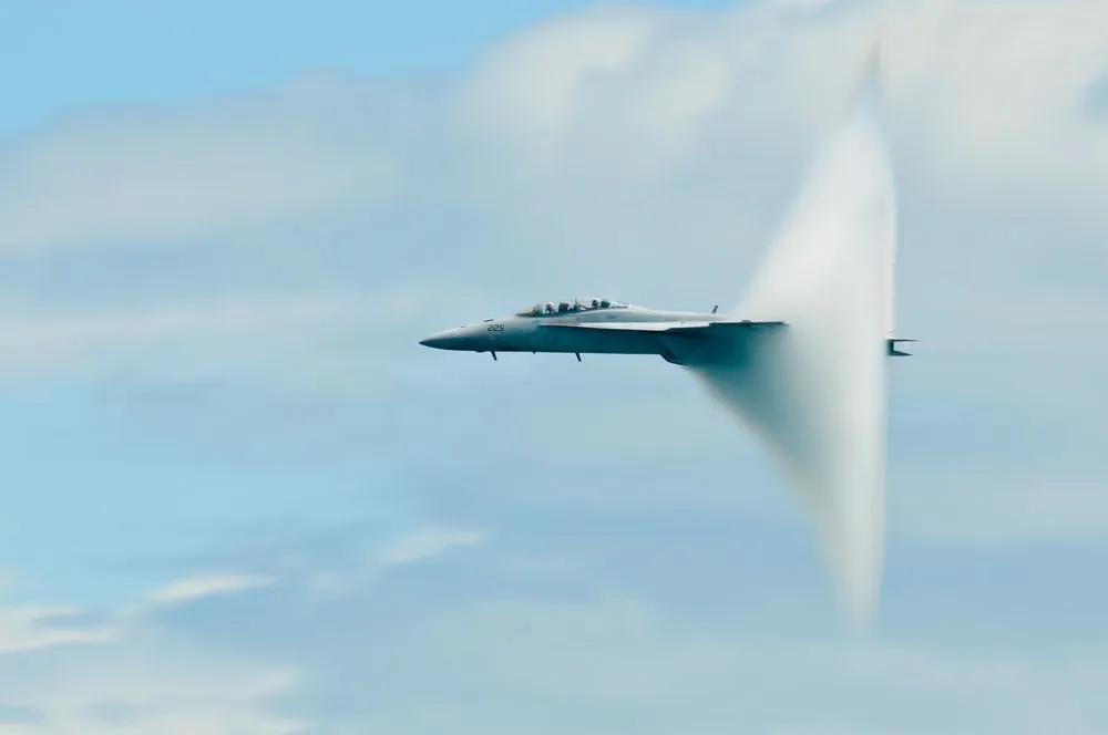 Military,Plane,Sound,Barier.,Military,Plane,On,Blue,,Cloudy,Sky