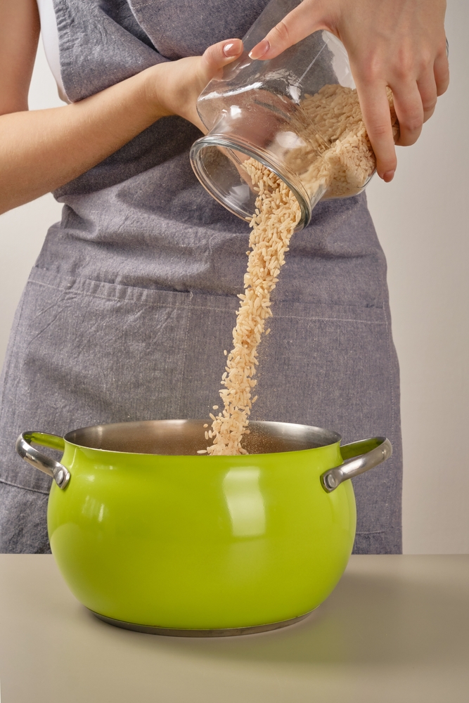 Chef,Woman's,Hands,Pour,Rice,Grains,From,A,Glass,Jar