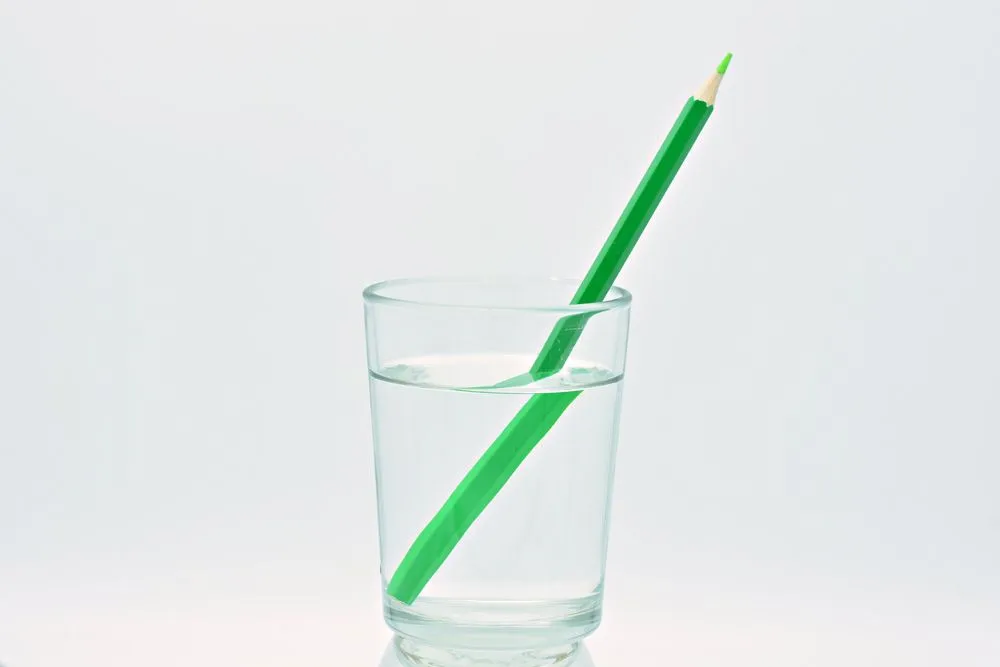Green,Colored,Pencil,Inside,A,Glass,Of,Water,,Light,Refraction