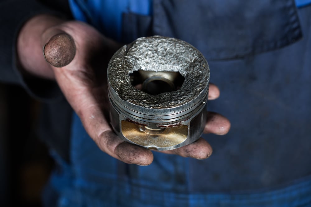 Car,Mechanic,Hand,With,Damaged,Engine,Valve,Piston,At,Repair