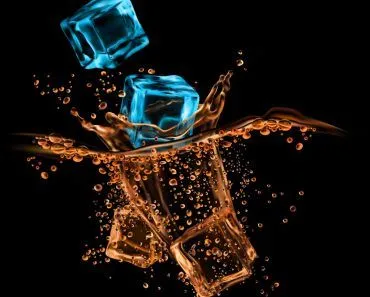 Ice-crystal-cubes-falling-to-whiskey-cognac-or-rum-bourbon-or-brandy-alcohol-drink