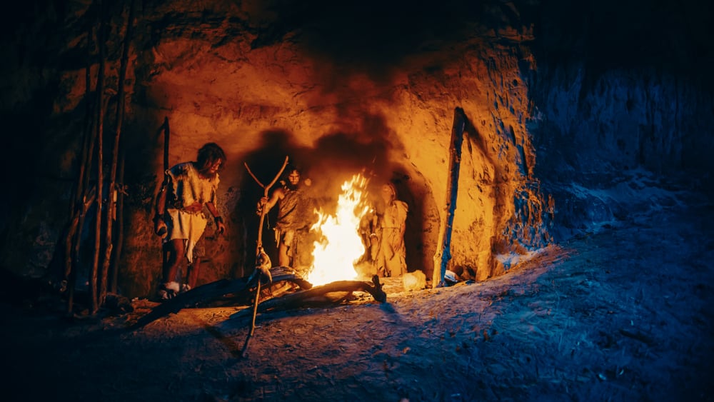 Tribe,Of,Prehistoric,Hunter-gatherers,Wearing,Animal,Skins,Stand,Around,Bonfire