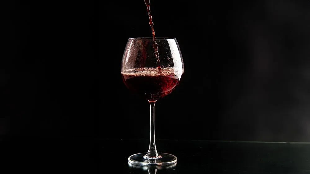 Red wine is poured up to the widest part of the glass so that there is space for the volatile compounds to gather (Credits: KamranAydinov/Freepik)
