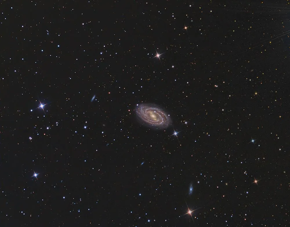 A distant galaxy surrounded by stars (Credits: rwittich/Envato Elements)