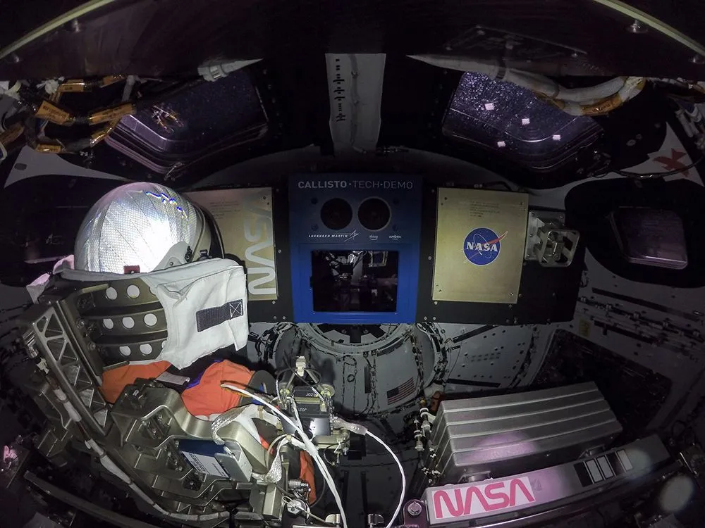 This image is taken from inside the Orion module, part of the Artemis 1 mission. On the left is Commander Moonikin Campos, who is equipped with sensors to collect data on space environments. (Credits: NASA)